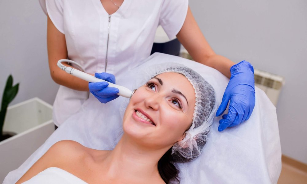 Young Happy Female Getting Hydrafacial Treatment | Glow Wellness Care in East Northport, NY